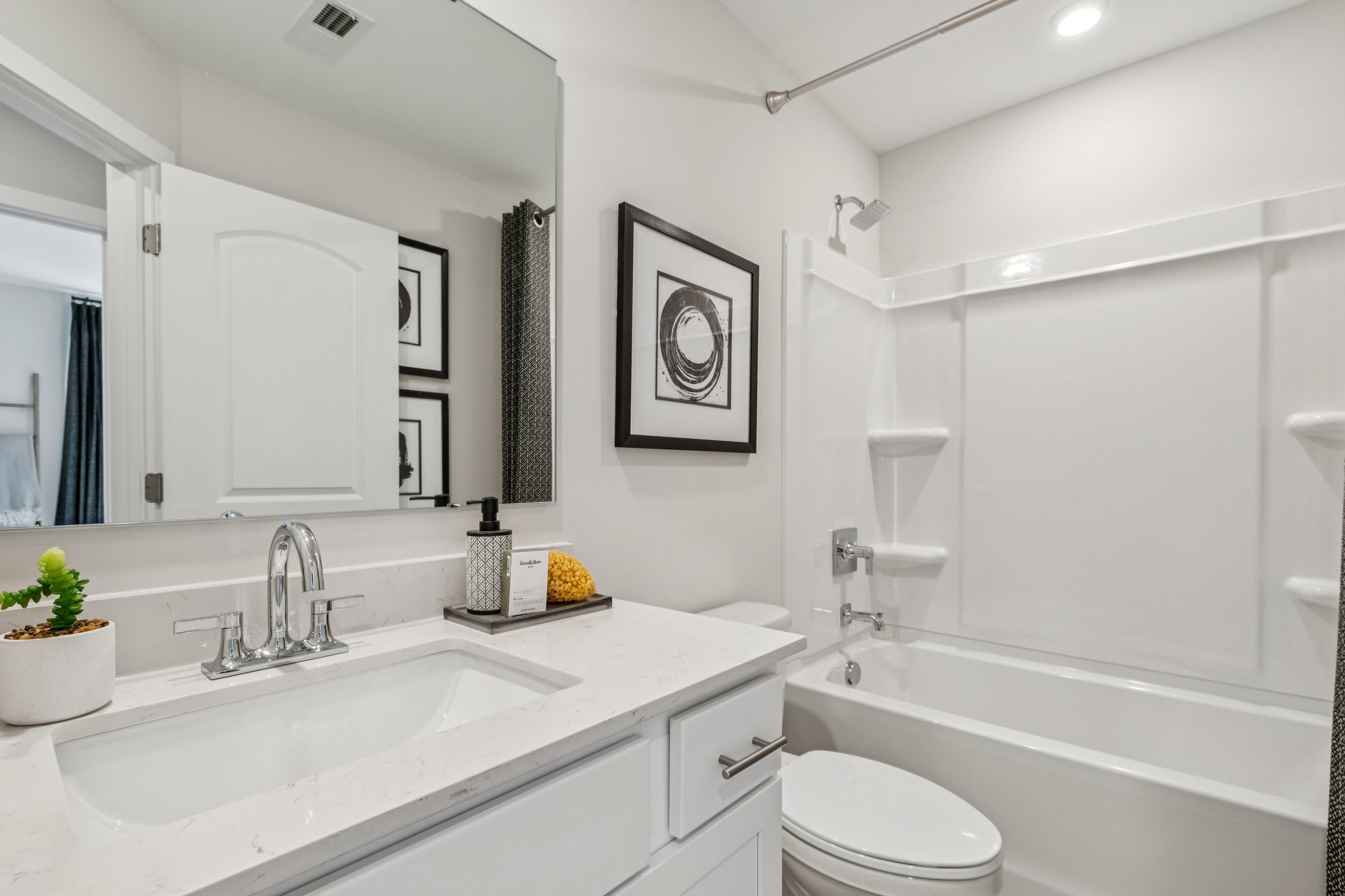 A bathroom with a tub sink and toilet.