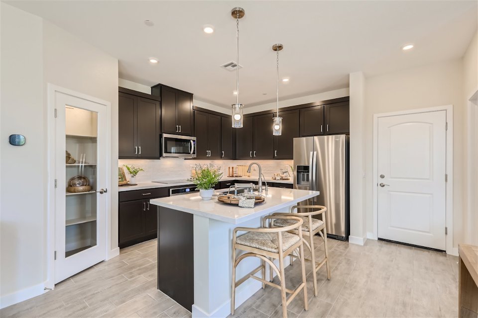 A kitchen with black cabinets.