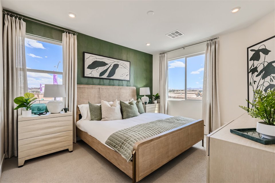 A bedroom with a large window.