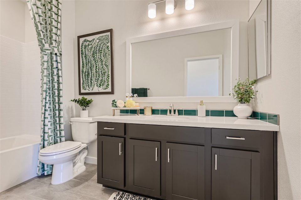 A bathroom with a tub sink and toilet.