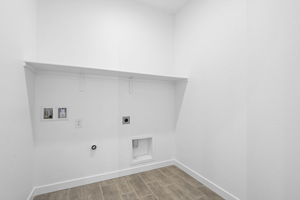 A white wall with pictures on it.