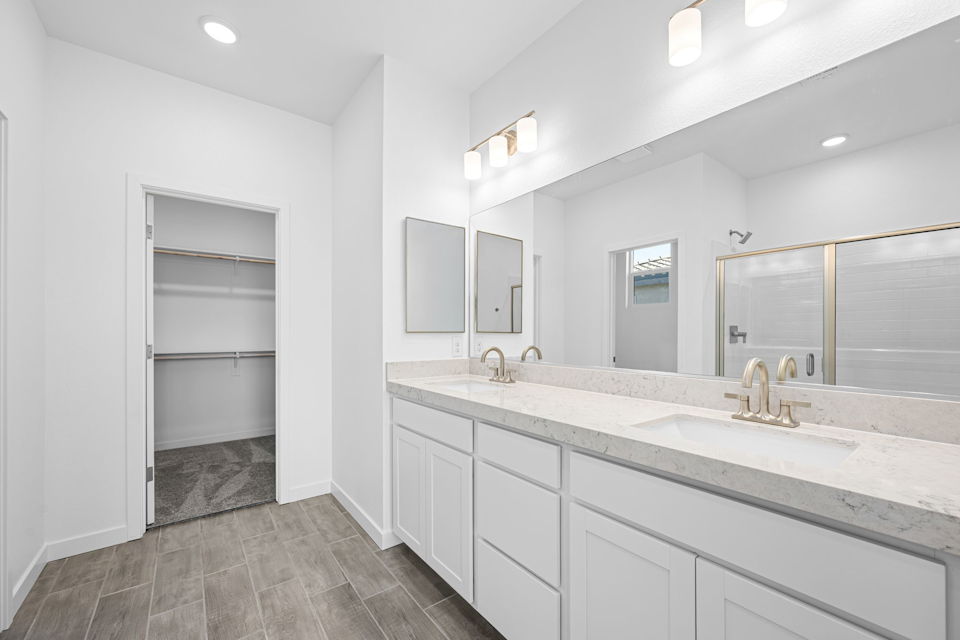 A bathroom with a large mirror.