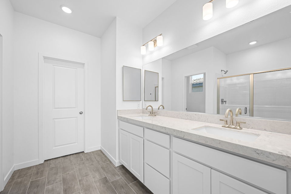 A bathroom with a large mirror.