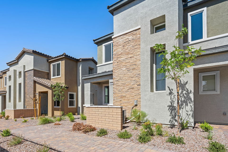 A brick building with a tree in front of it.