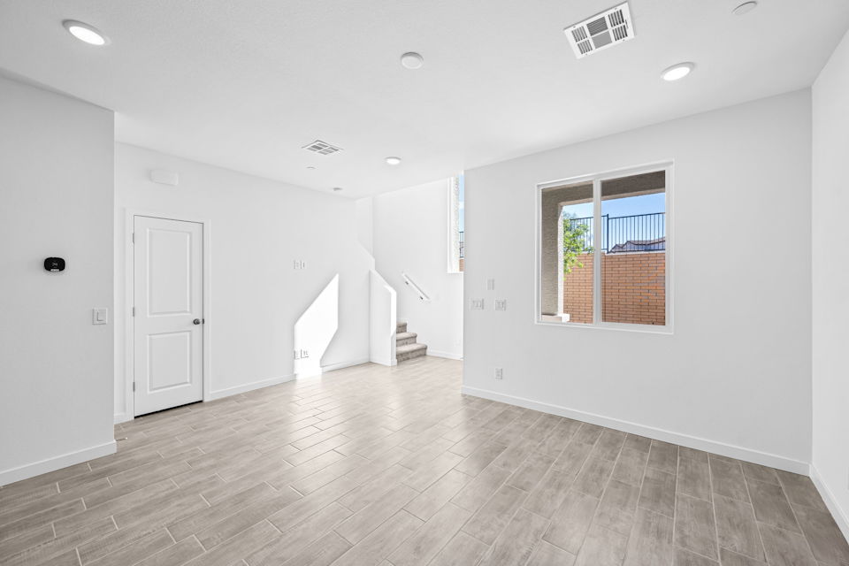A room with white walls and a wood floor.