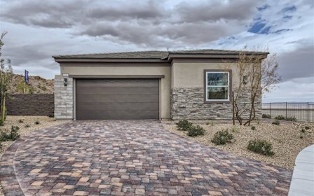 A house with a brick driveway.