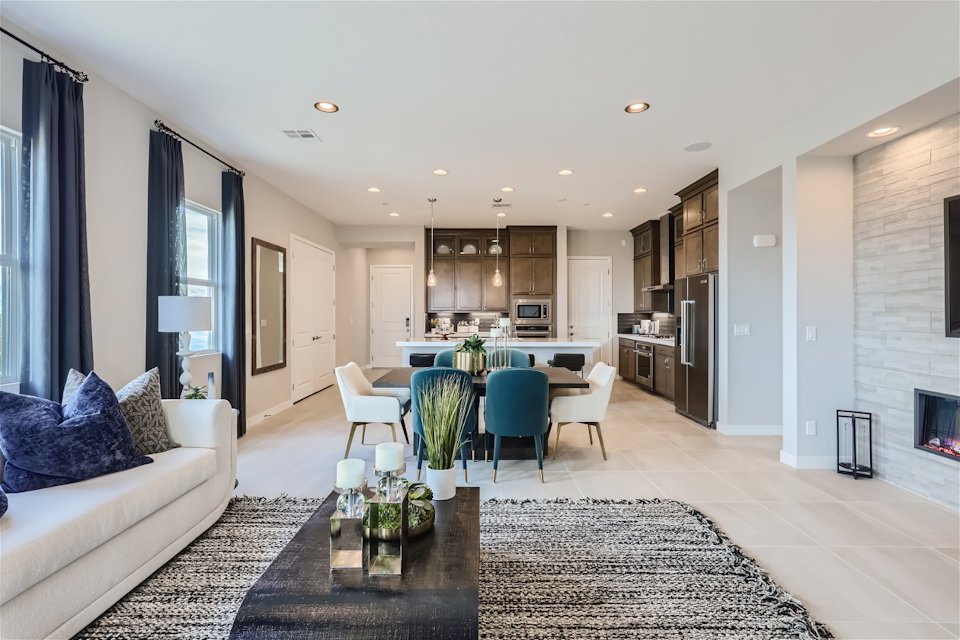 A living room with a dining table and couches.