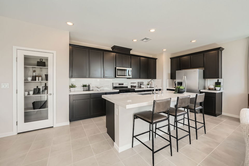 A kitchen with black cabinets.