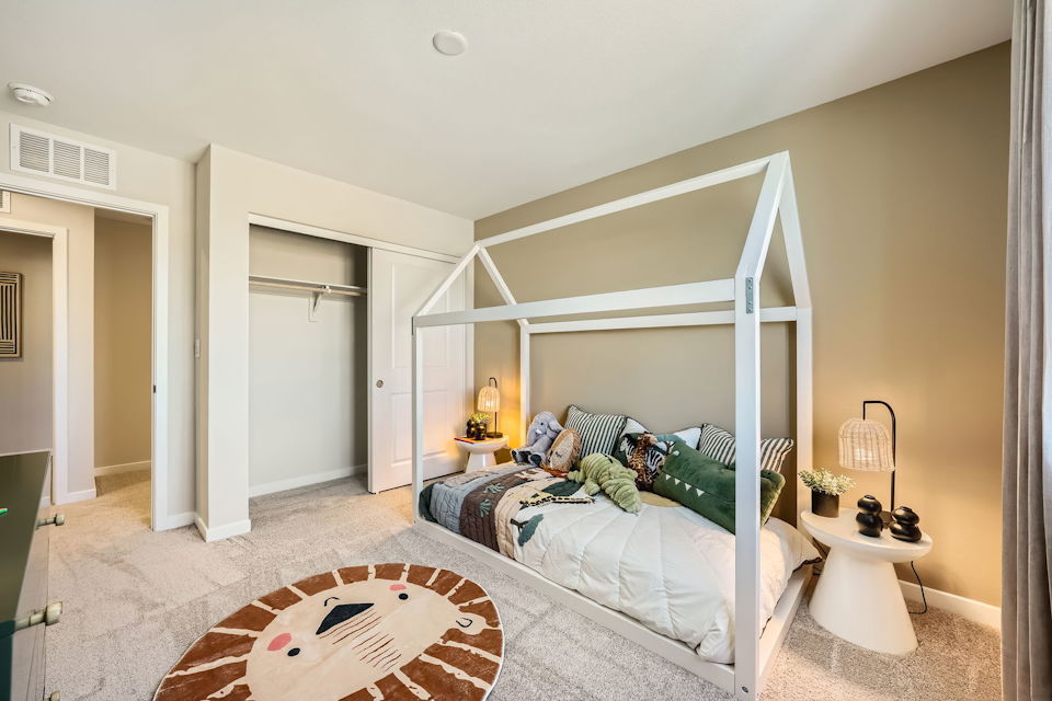 A bedroom with a bed and a rug.