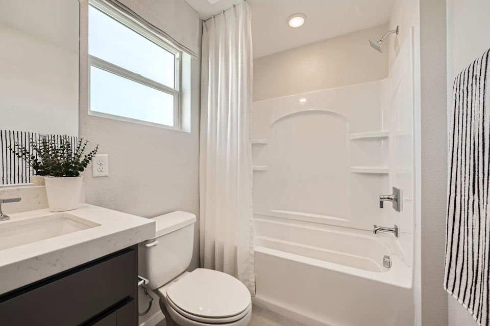 A bathroom with a tub toilet and sink.