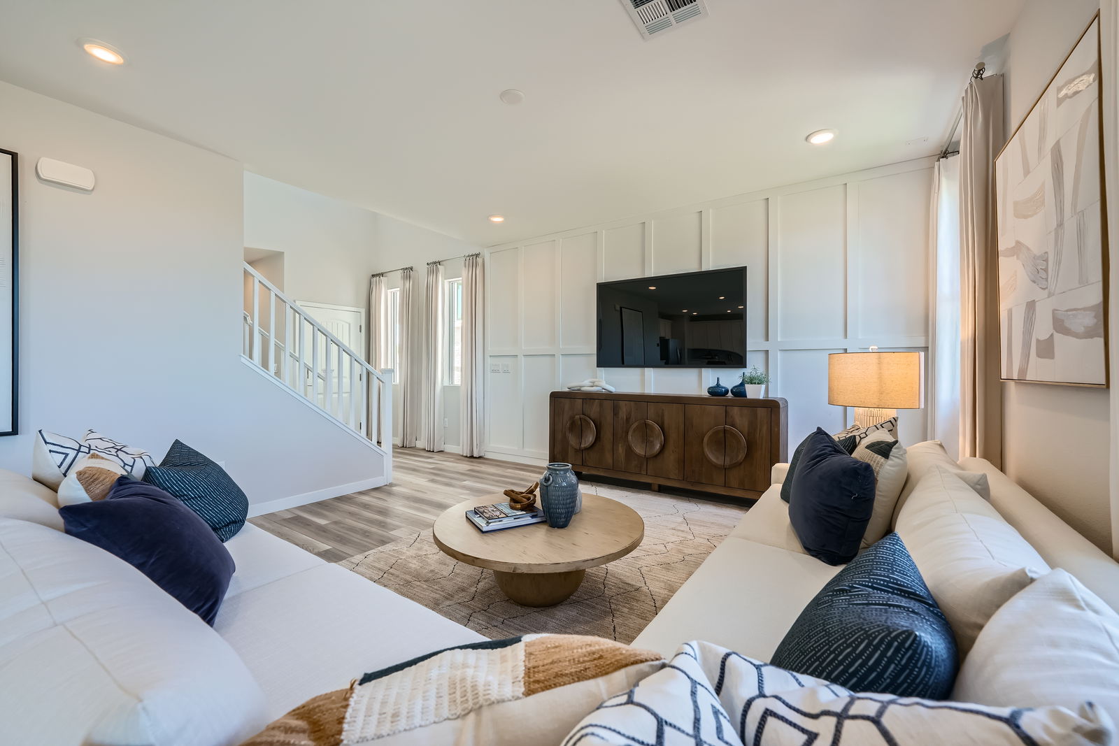 A living room with a large tv and a couch.