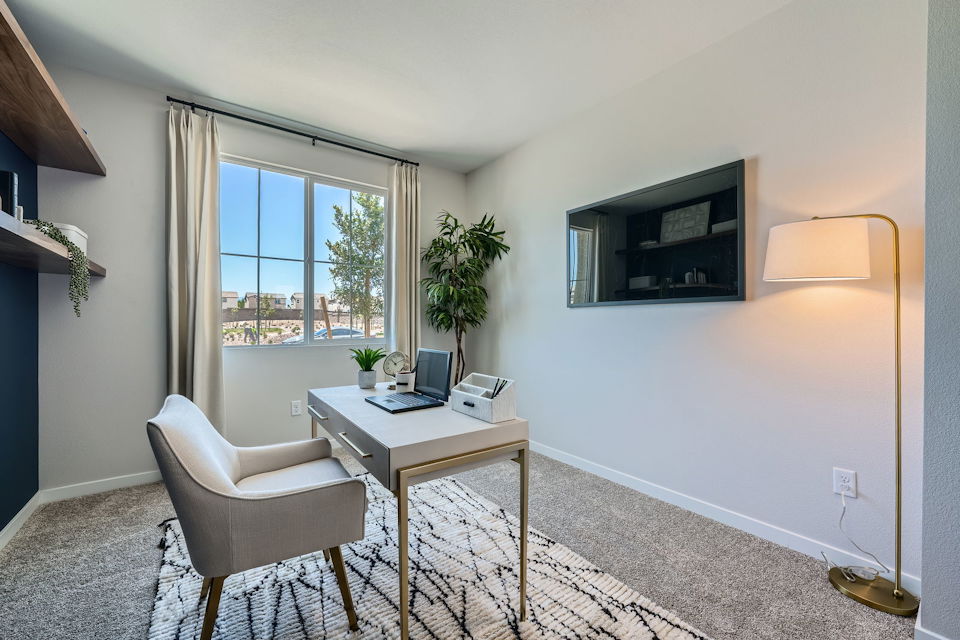 A room with a desk and a chair.