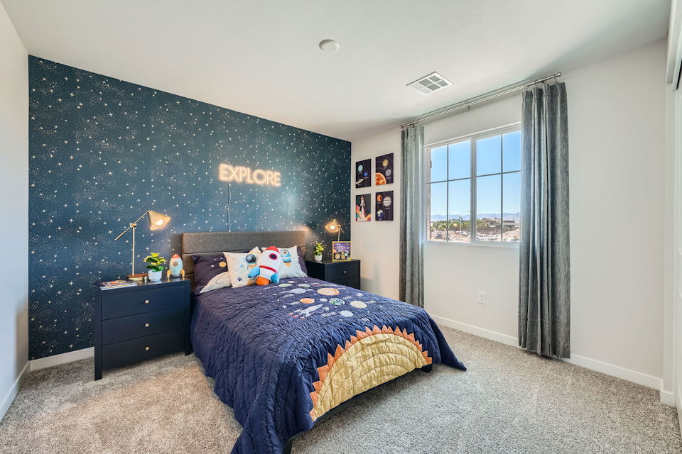 A bedroom with a blue bed.