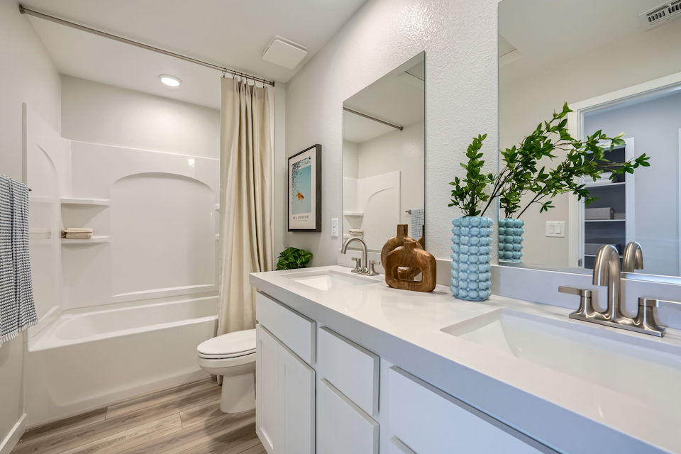 A bathroom with a tub sink and toilet.