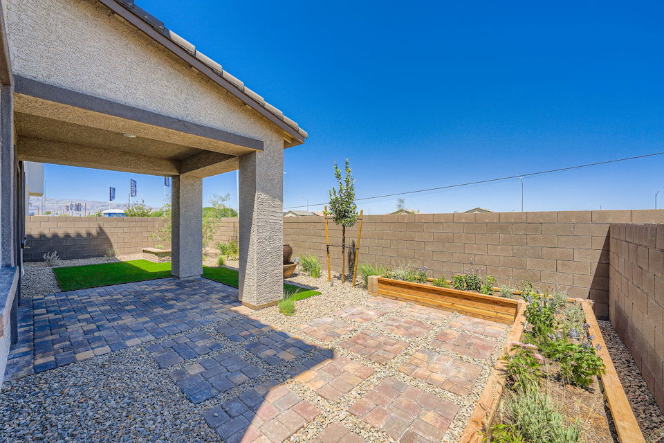 A brick patio with a brick wall and a brick walkway.