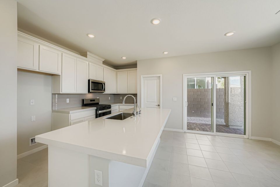 A kitchen with white cabinets.