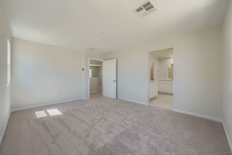 A long hallway with white doors.