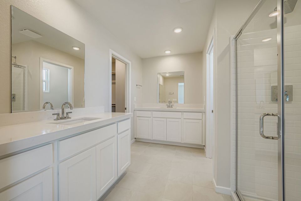 A bathroom with white cabinets.
