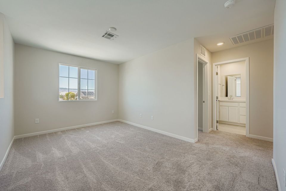 A room with a carpet and a window.