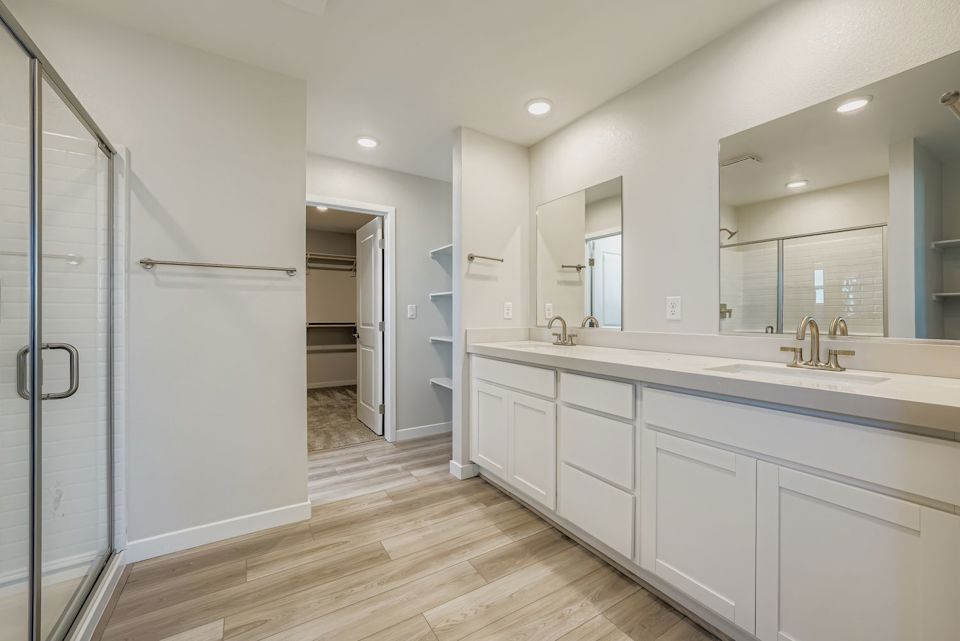 A bathroom with white cabinets.