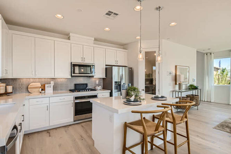 A kitchen with white cabinets.