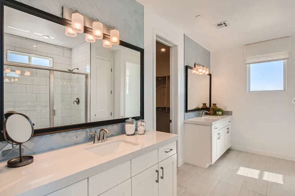 A bathroom with a large mirror.