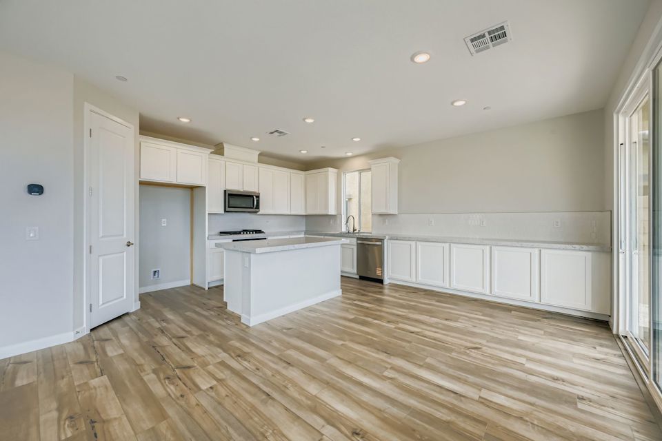 A kitchen with white cabinets.
