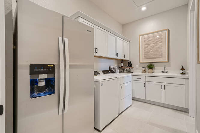 A kitchen with white cabinets.