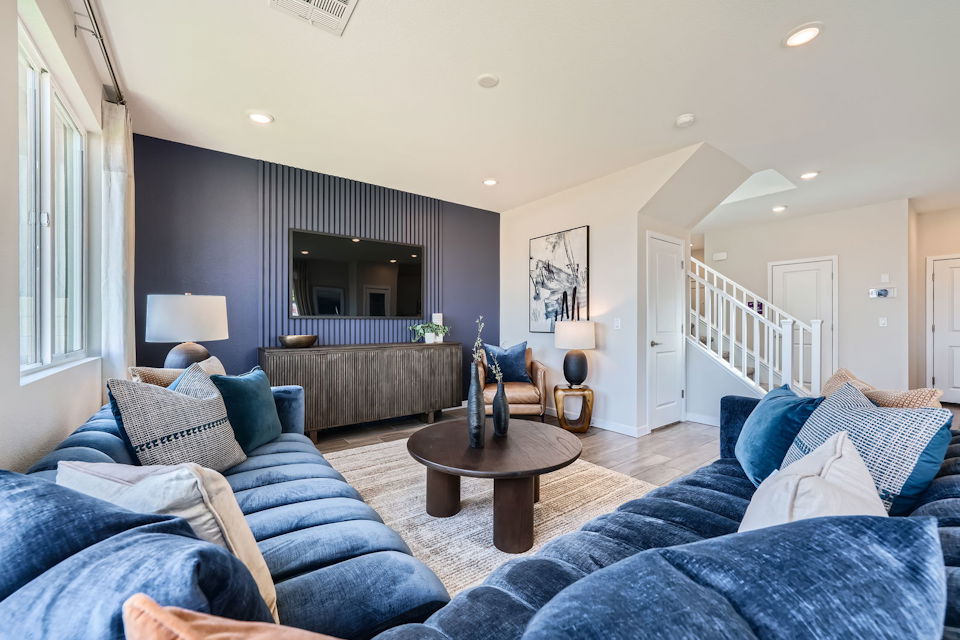 A living room with blue couches.