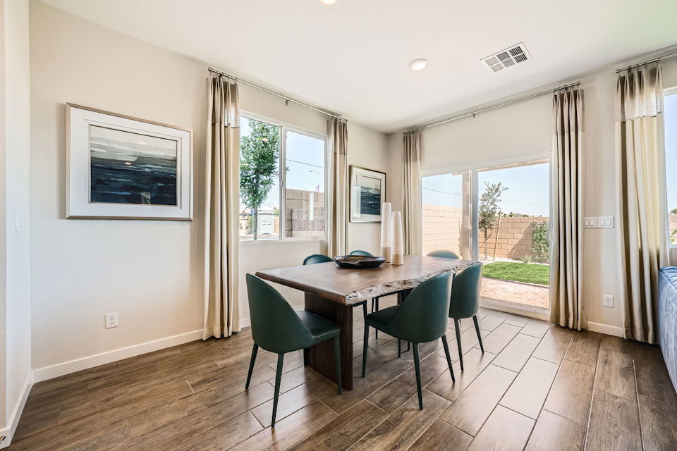 A dining room table with chairs.