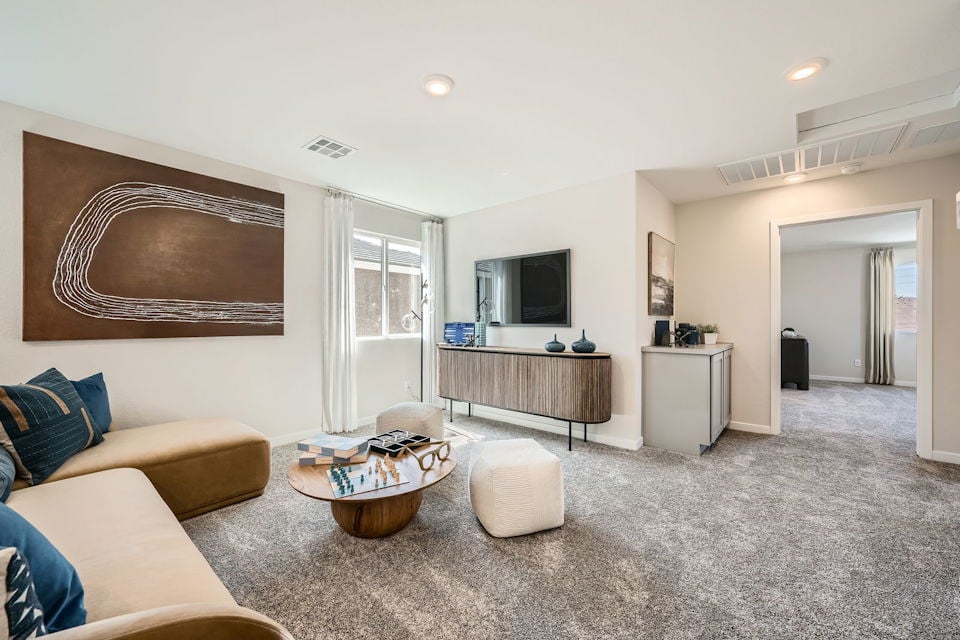 A living room with a large tv and couches.