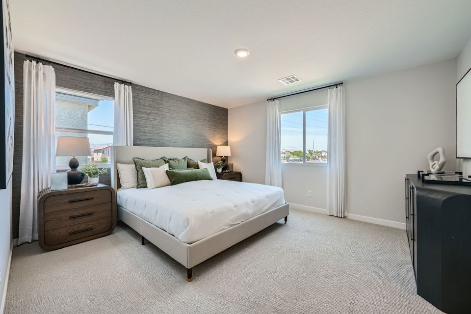 A bedroom with a bed and a dresser.