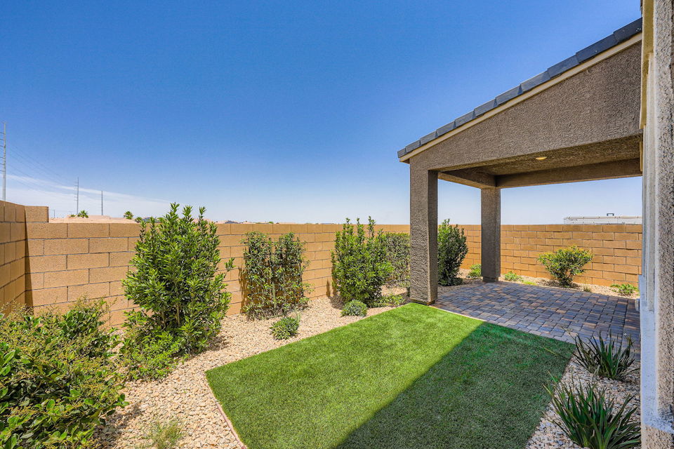 A backyard with a brick building.