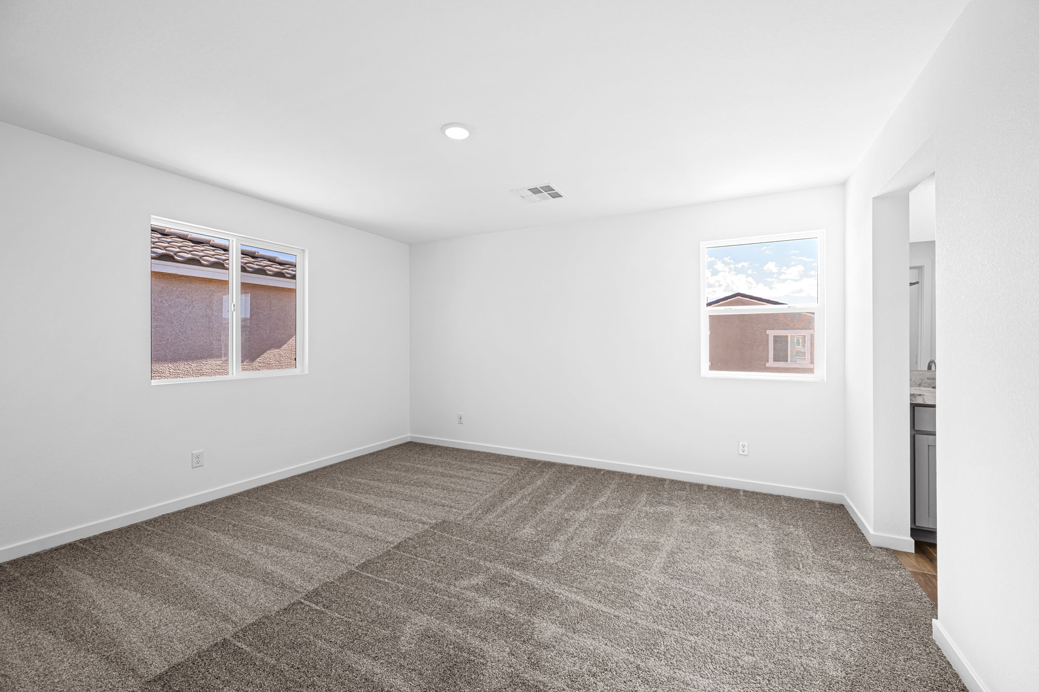 A room with a carpet and a window.