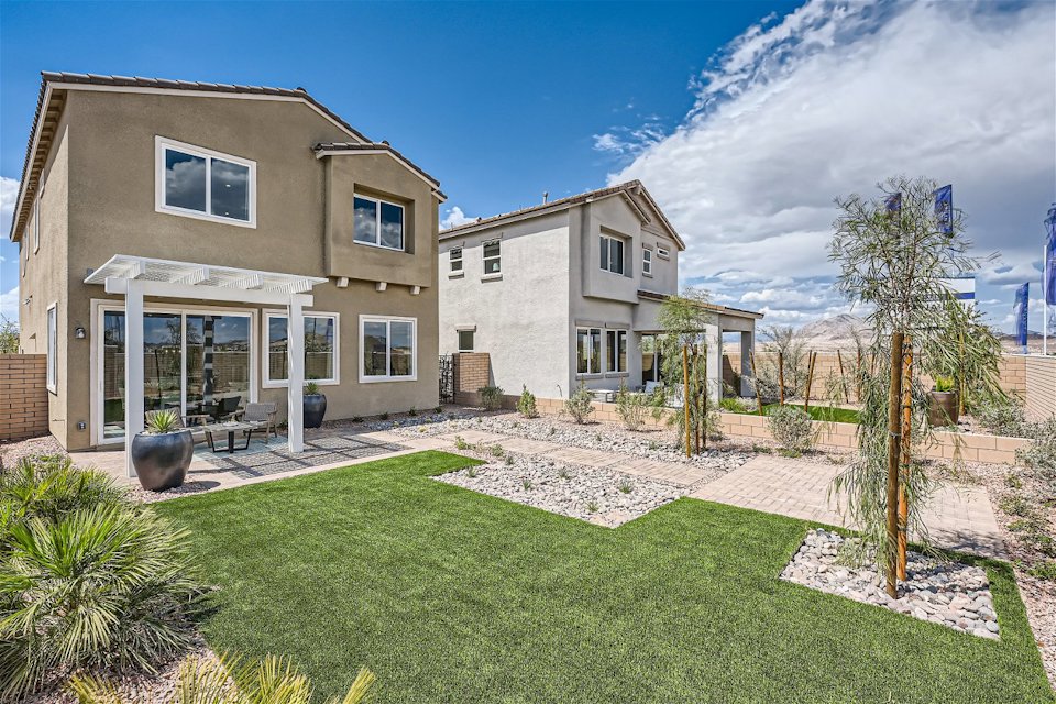 A building with a lawn and trees.