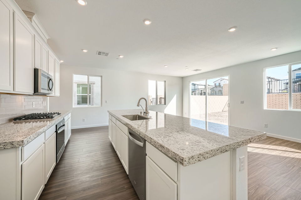 A kitchen with marble counters.