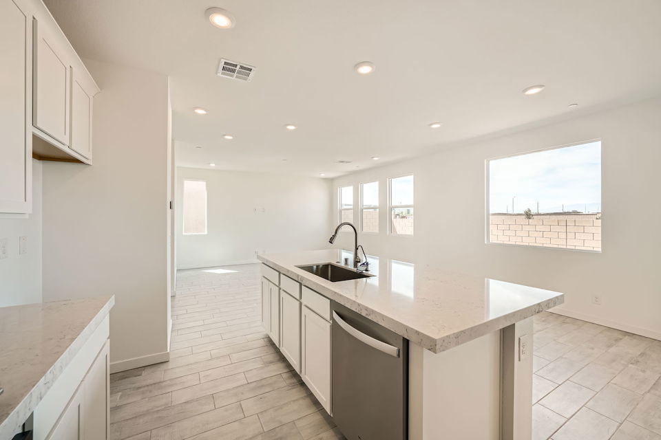 A kitchen with white cabinets.