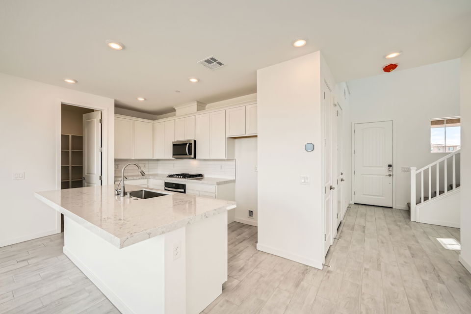 A kitchen with white cabinets.