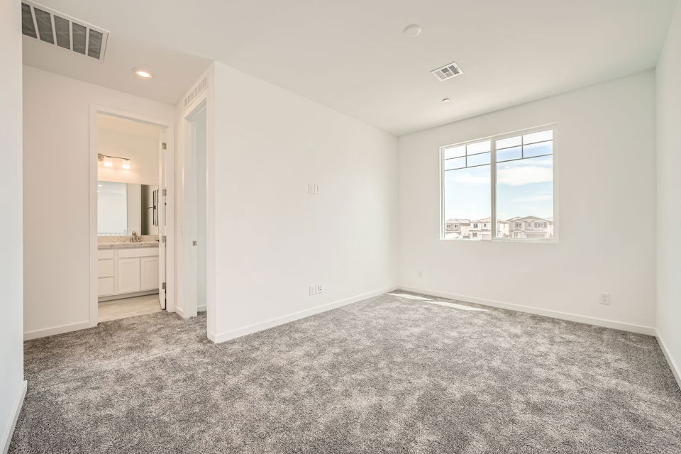 A room with a window and a desk.