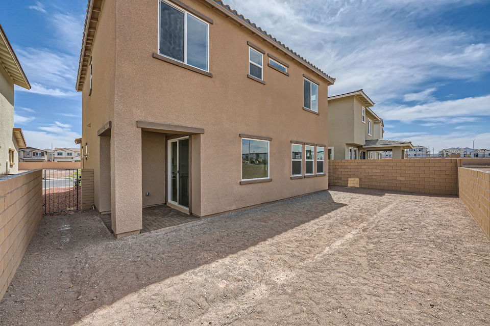 A building with a dirt yard.