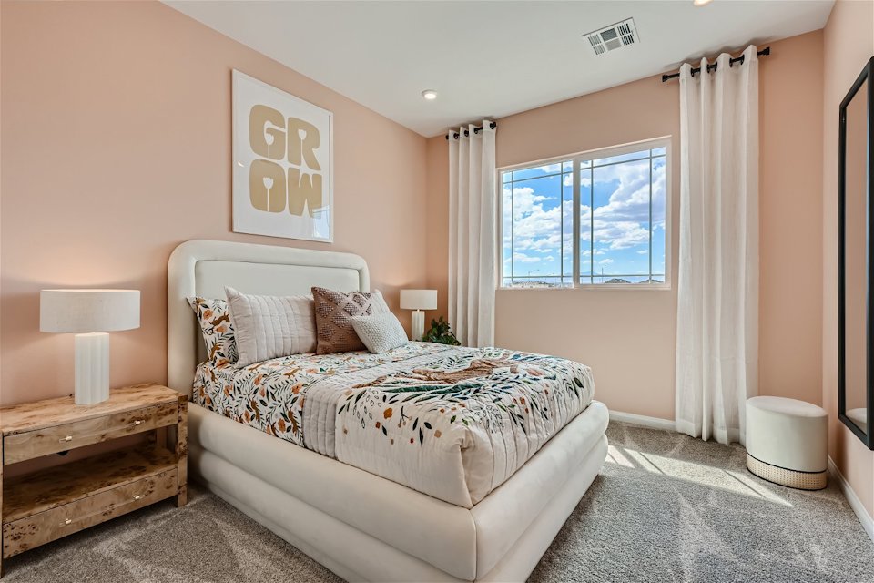 A bedroom with a bed and a window.