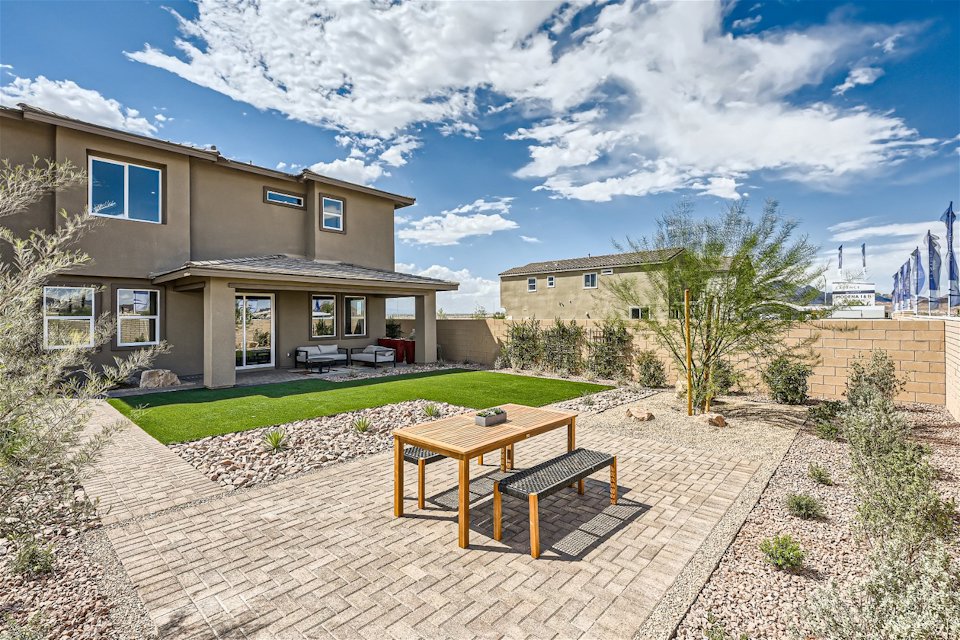 A patio with tables and chairs in front of a building.