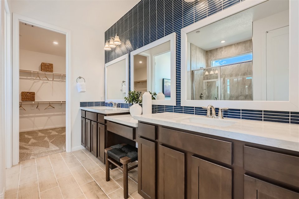 A bathroom with a large mirror.