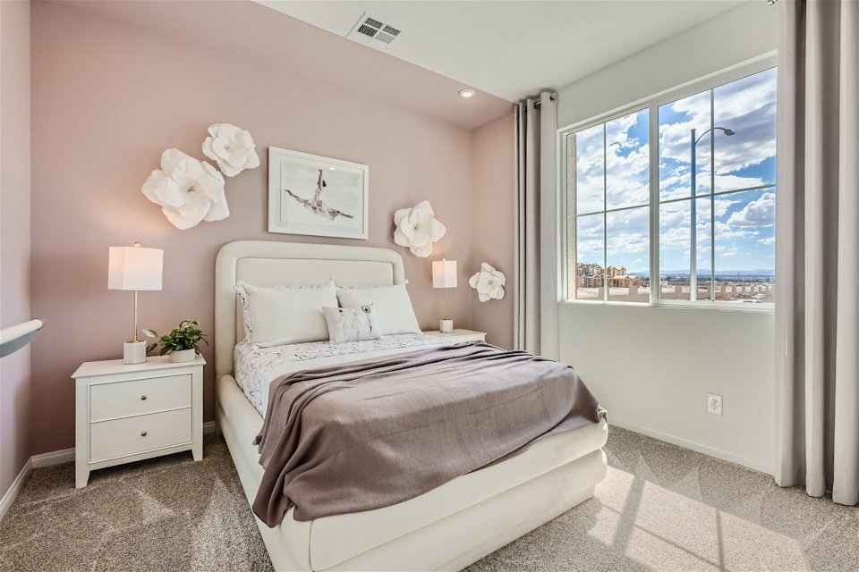 A bedroom with a large window.