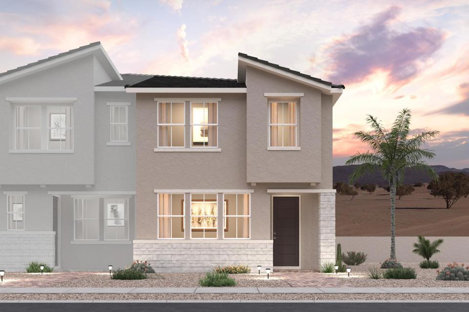 A large white house with a palm tree in the front.