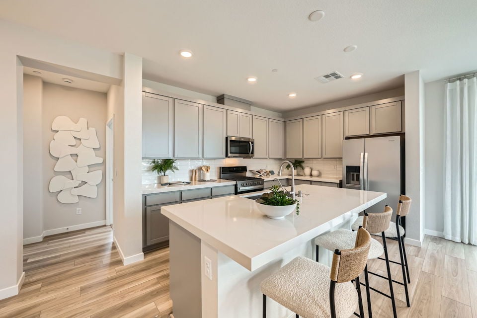 A kitchen with white cabinets.
