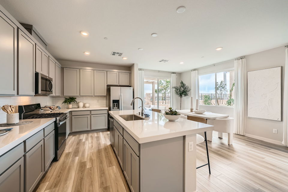 A kitchen with white cabinets.