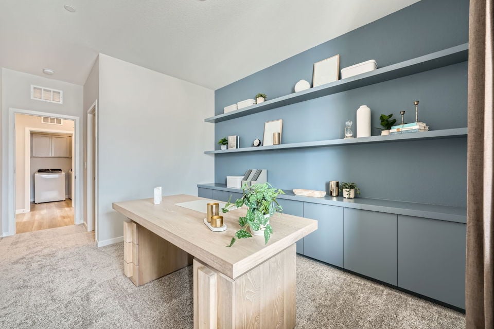 A room with a table and shelves.