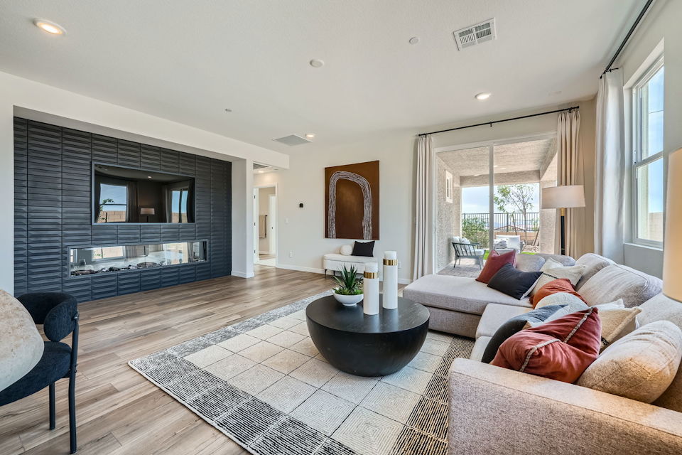 A living room with a large rug.