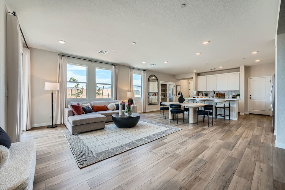 A large living room with a wood floor.